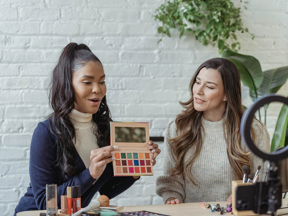 two women filming a video review on a makeup